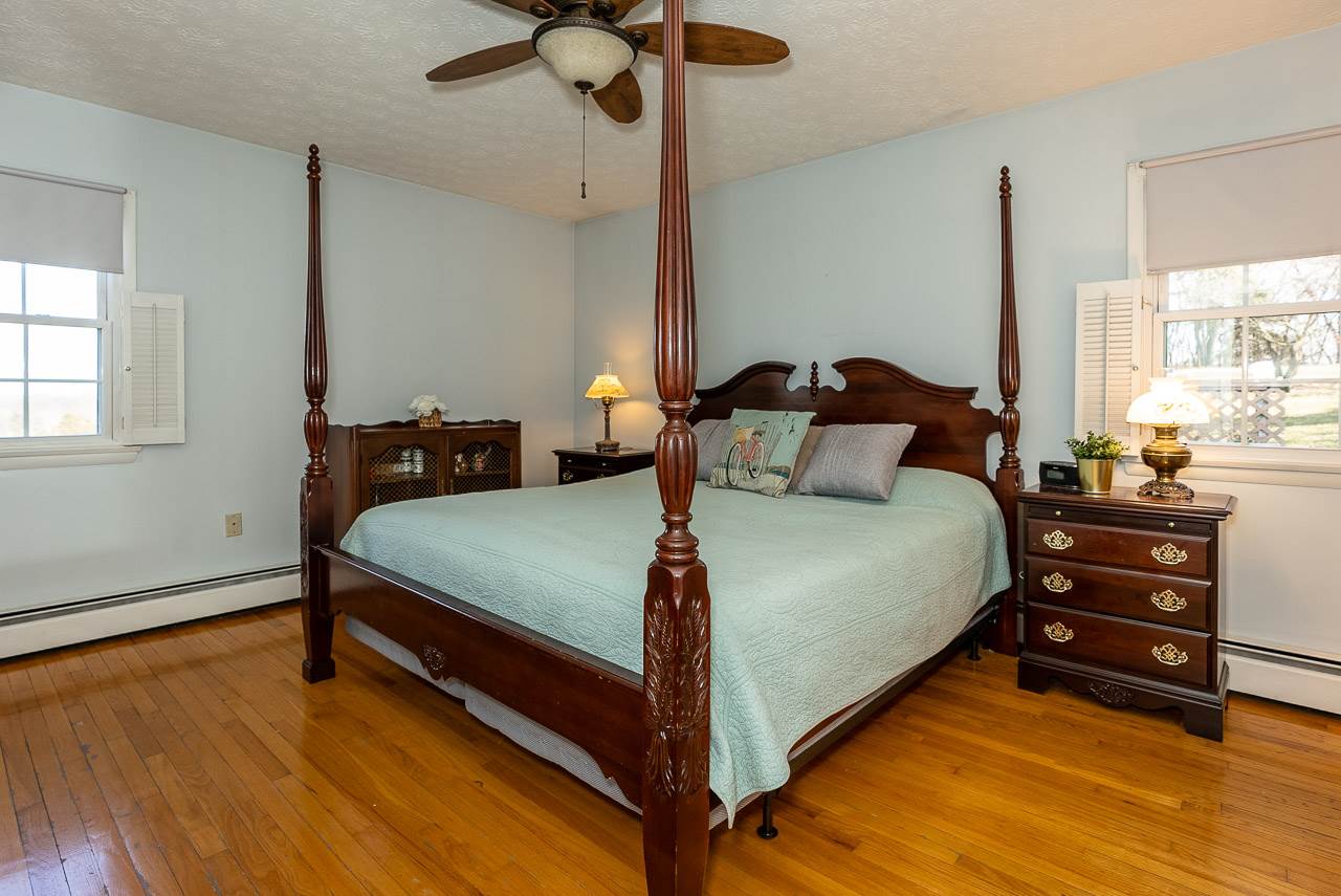 3663 Spring Hill Road Staunton, VA 24401 - Photo 17 of 50 a bedroom with a bed and wooden floor