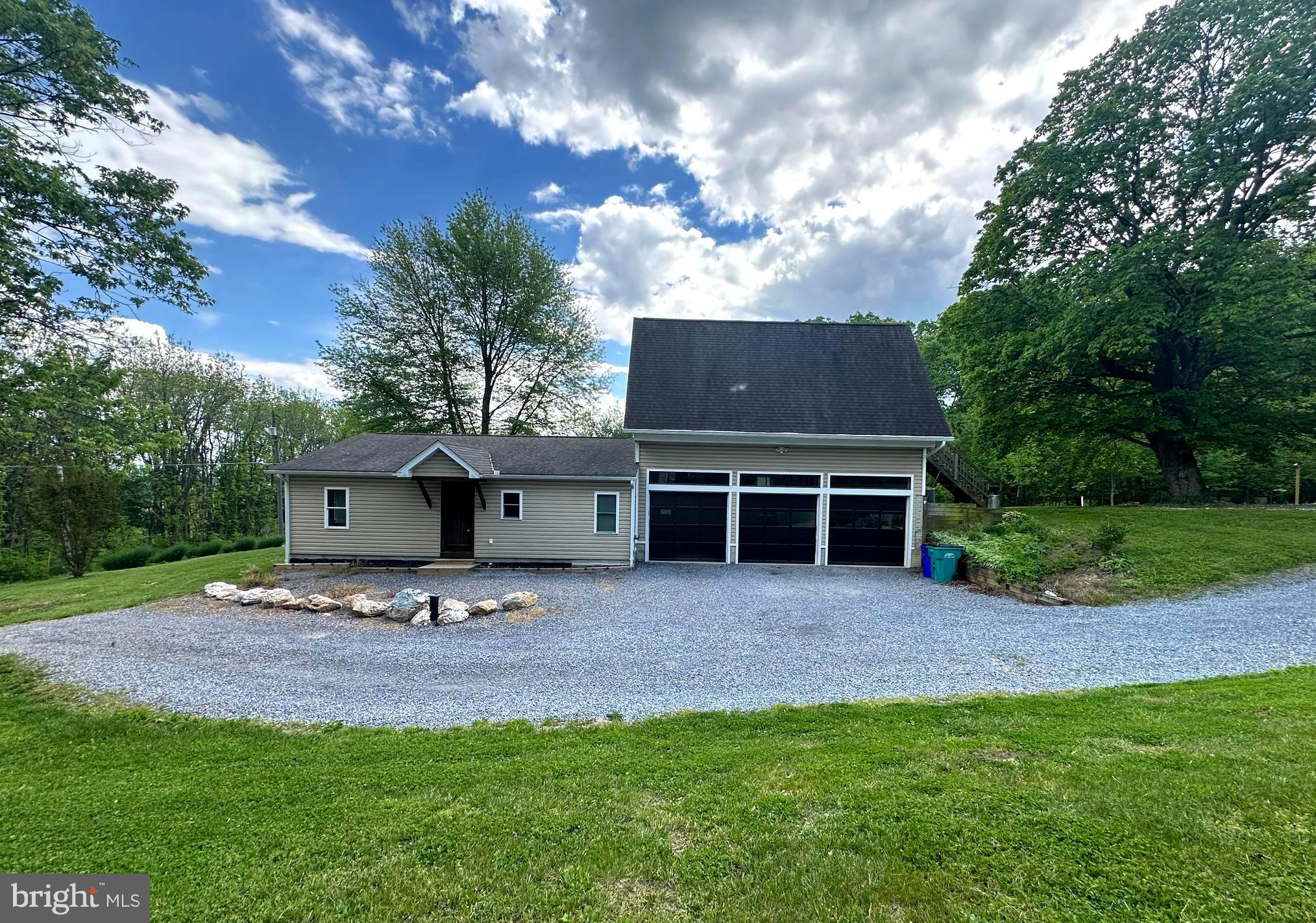 a view of house with backyard and outdoor seating