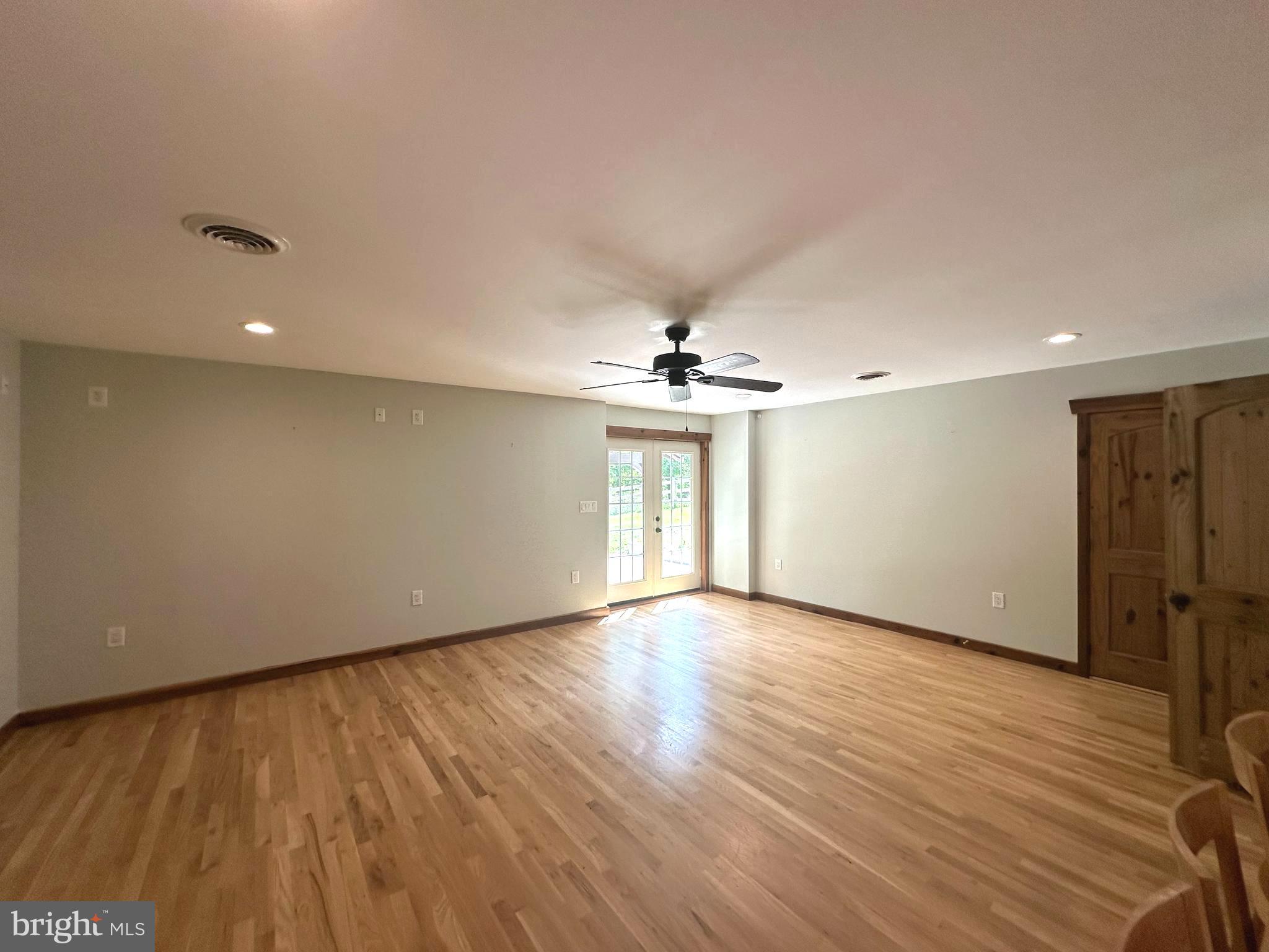 3720 Basford Road Frederick, MD 21703 - Photo 15 of 38 a view of an empty room with a window and wooden floor