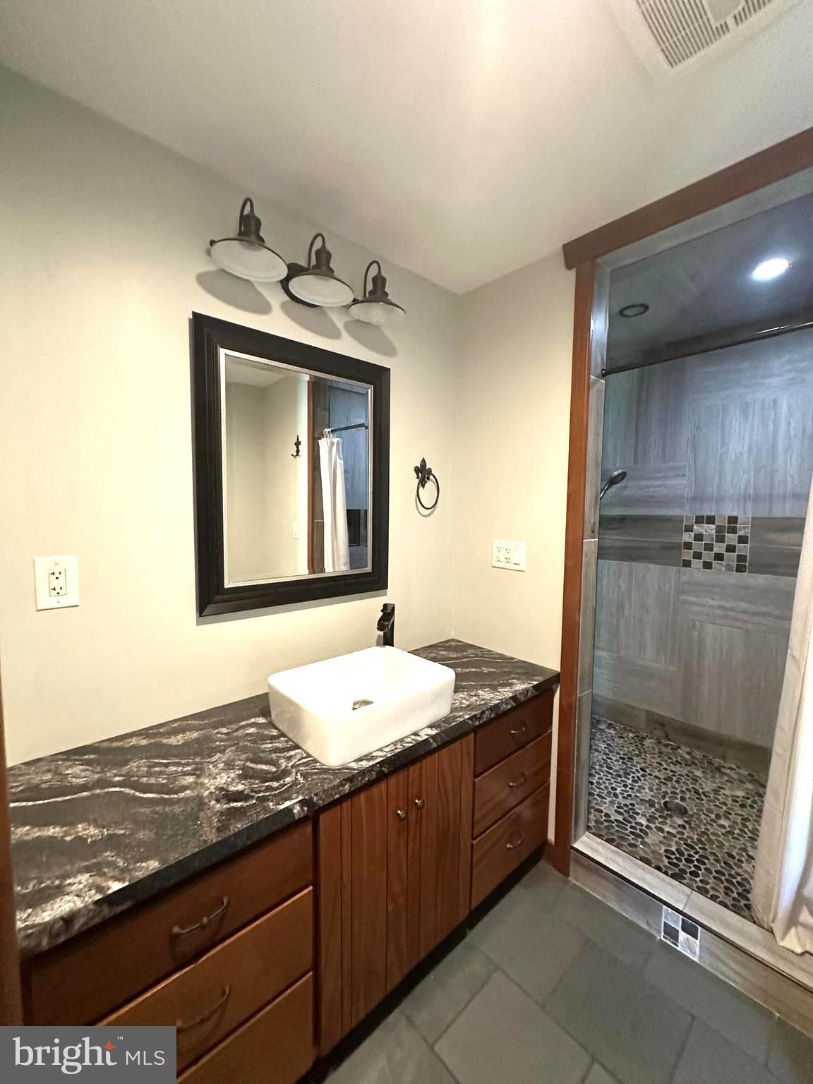 3720 Basford Road Frederick, MD 21703 - Photo 23 of 38 a bathroom with a granite countertop sink and a mirror