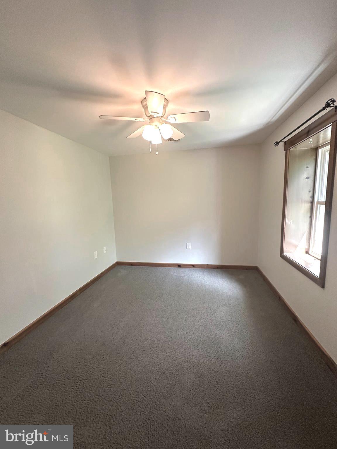 3720 Basford Road Frederick, MD 21703 - Photo 30 of 38 an empty room with a ceiling fan and a window