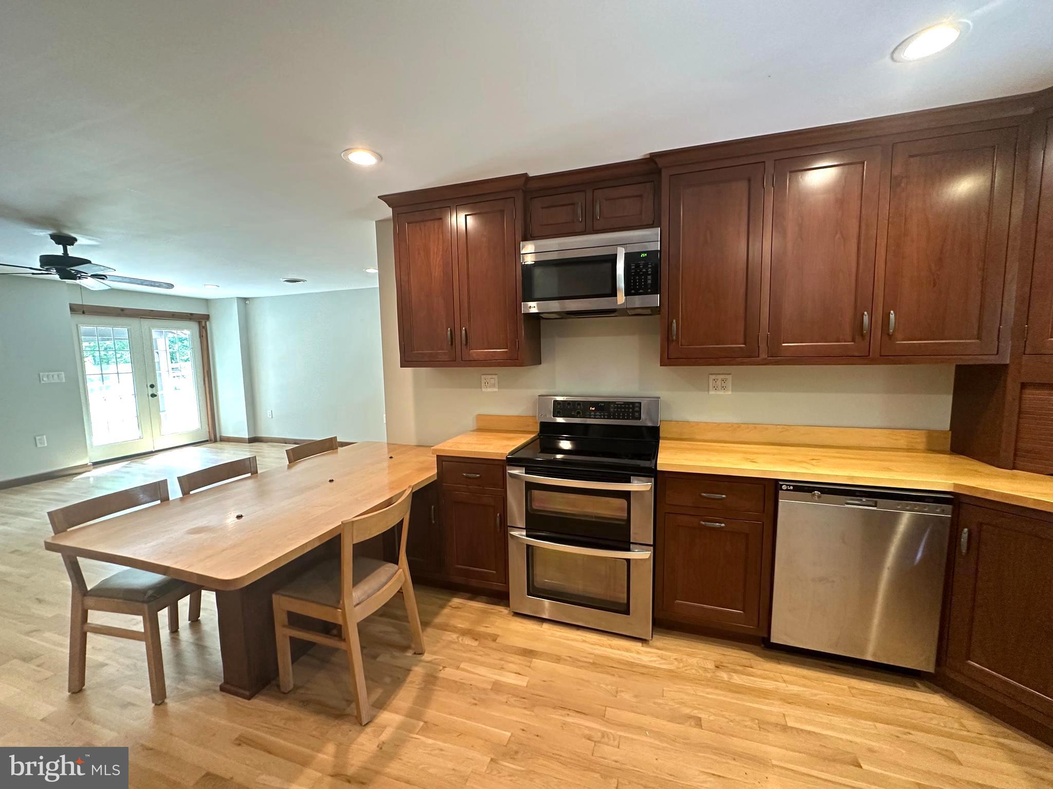 3720 Basford Road Frederick, MD 21703 - Photo 9 of 38 a kitchen with stainless steel appliances kitchen island granite countertop a sink and cabinets