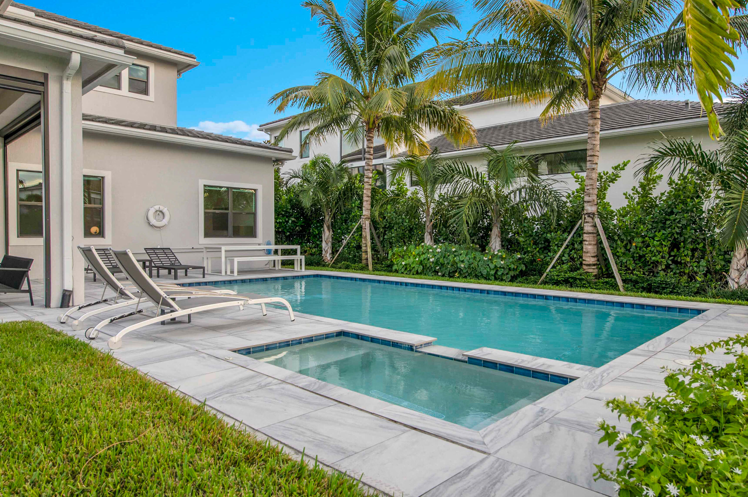 7480 Northwest 26th Way Boca Raton, FL 33496 - Photo 12 of 111 a view of a patio with table and chairs potted plants and palm tree