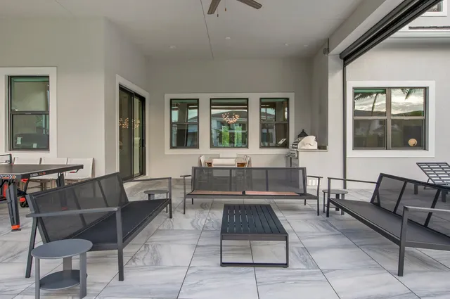 a living room with furniture and a dining table