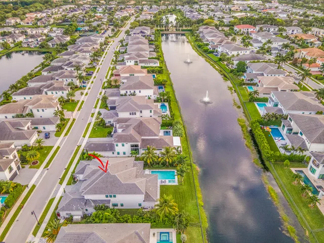 a view of a hallway with a ceiling fan and a rug