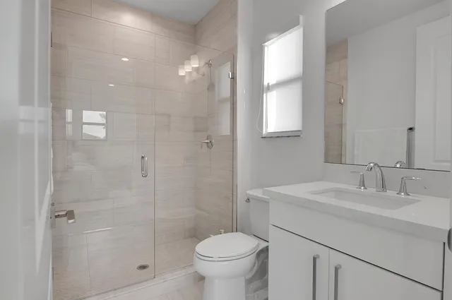 a room with furniture pool table flat screen tv and a chandelier