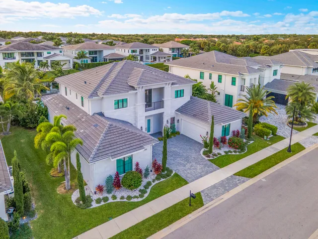 a view of a patio with table and chairs potted plants and palm tree