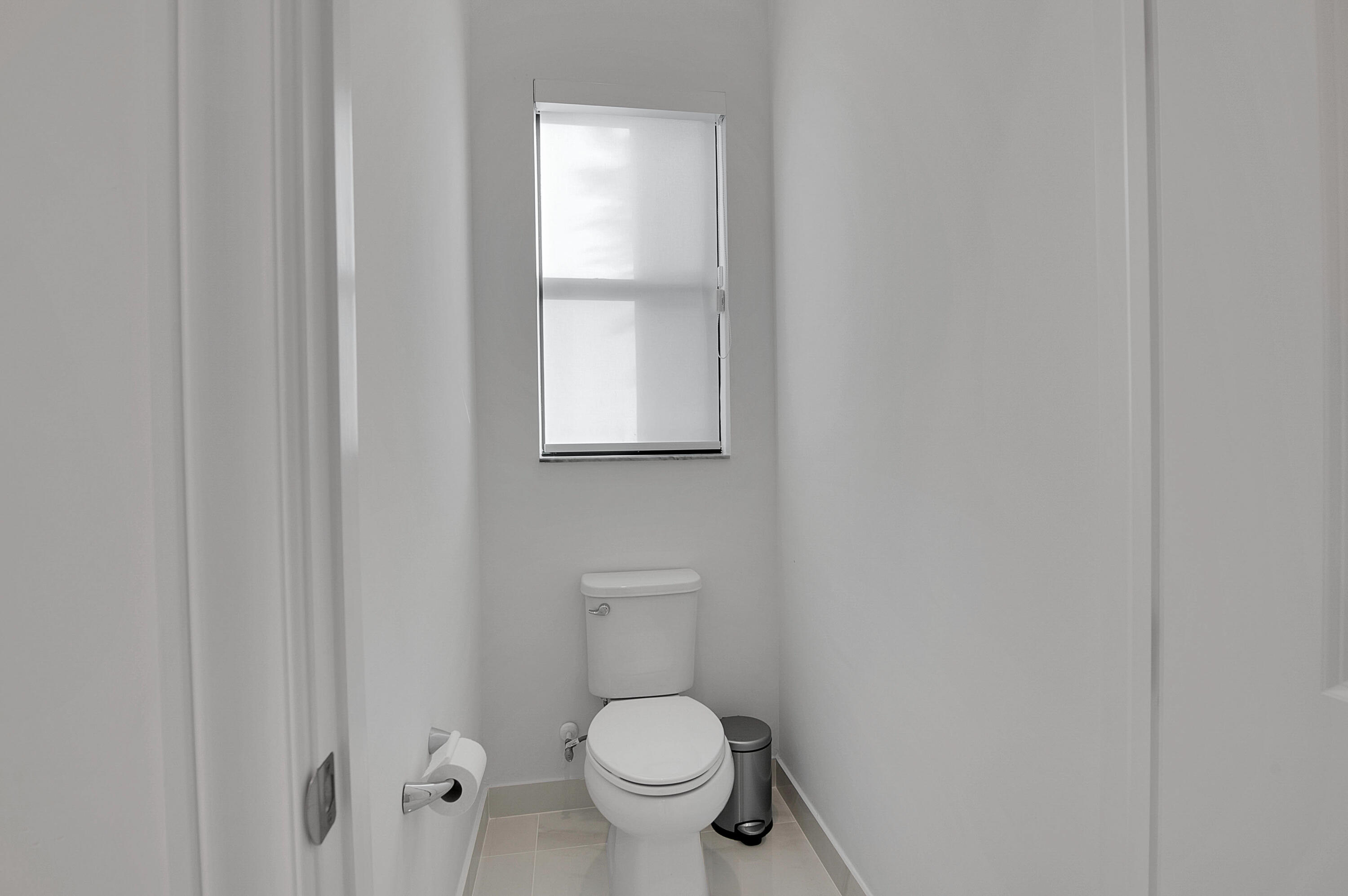 7480 Northwest 26th Way Boca Raton, FL 33496 - Photo 59 of 111 a white toilet sitting next to a window