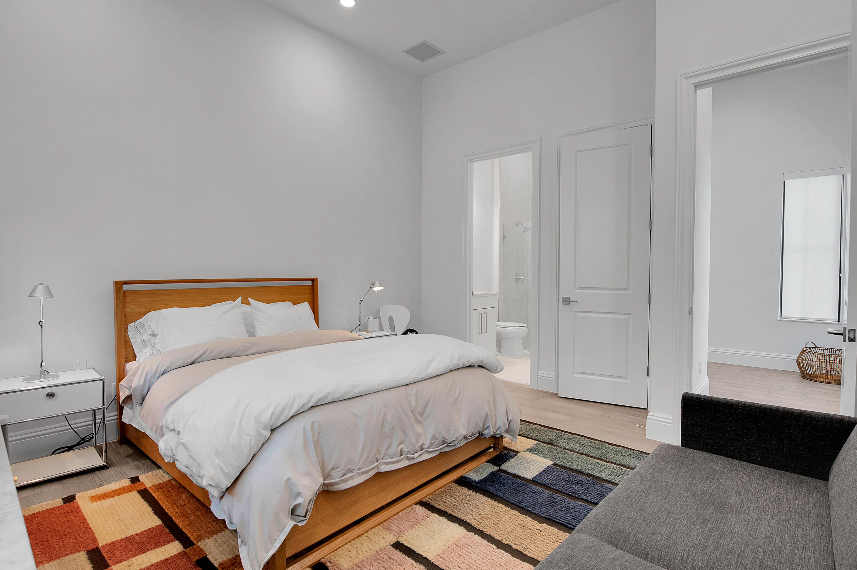 7480 Northwest 26th Way Boca Raton, FL 33496 - Photo 67 of 111 a bedroom with a bed and a couch