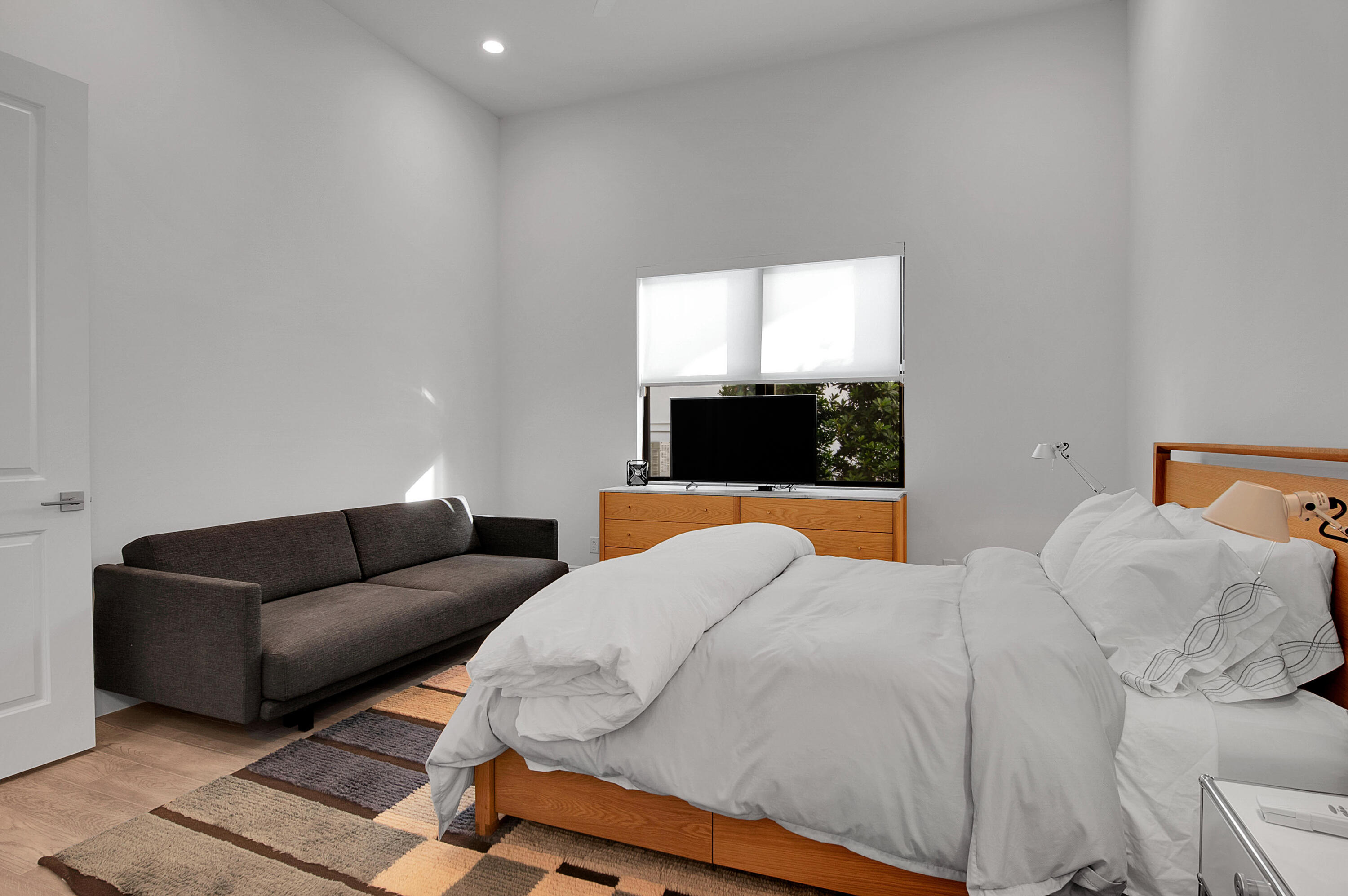 7480 Northwest 26th Way Boca Raton, FL 33496 - Photo 69 of 111 a bedroom with a bed and a couch