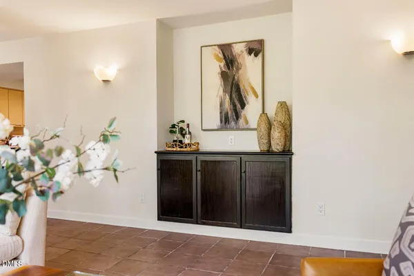 a living room with furniture and a floor to ceiling window