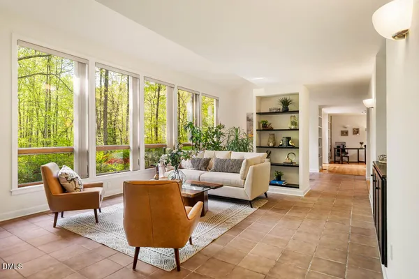 a view of a livingroom with workspace and a window