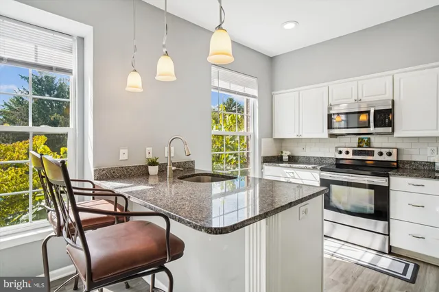 a view of a kitchen with a sink and a window
