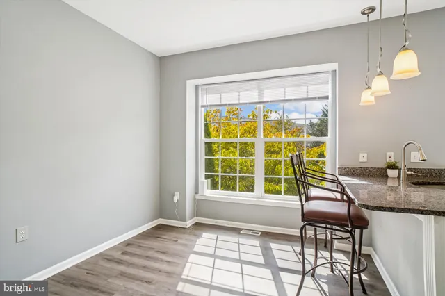 a view of kitchen with furniture and wooden floor