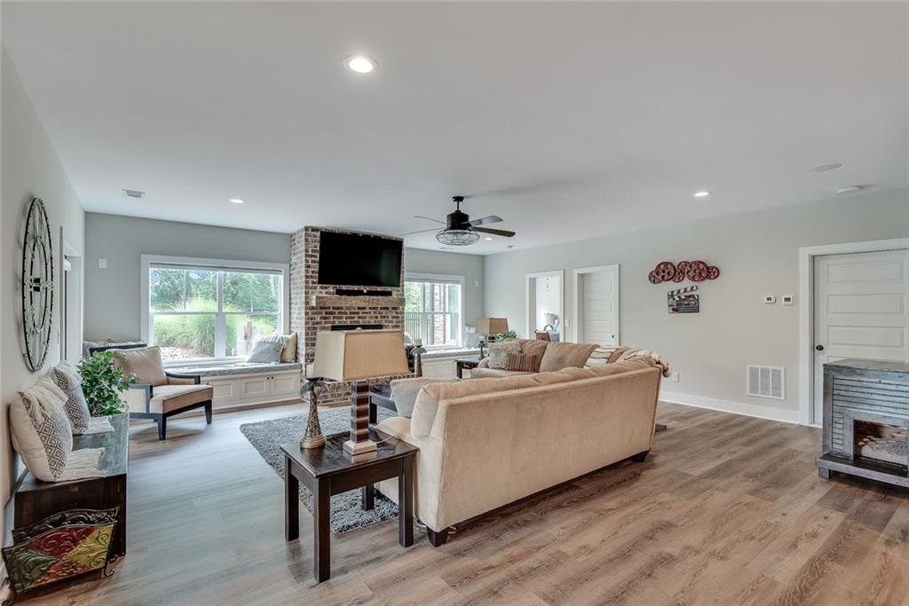 2503 Sugar Pike Road Canton, GA 30115 - Photo 127 of 134 a living room with furniture flat screen tv and a fireplace