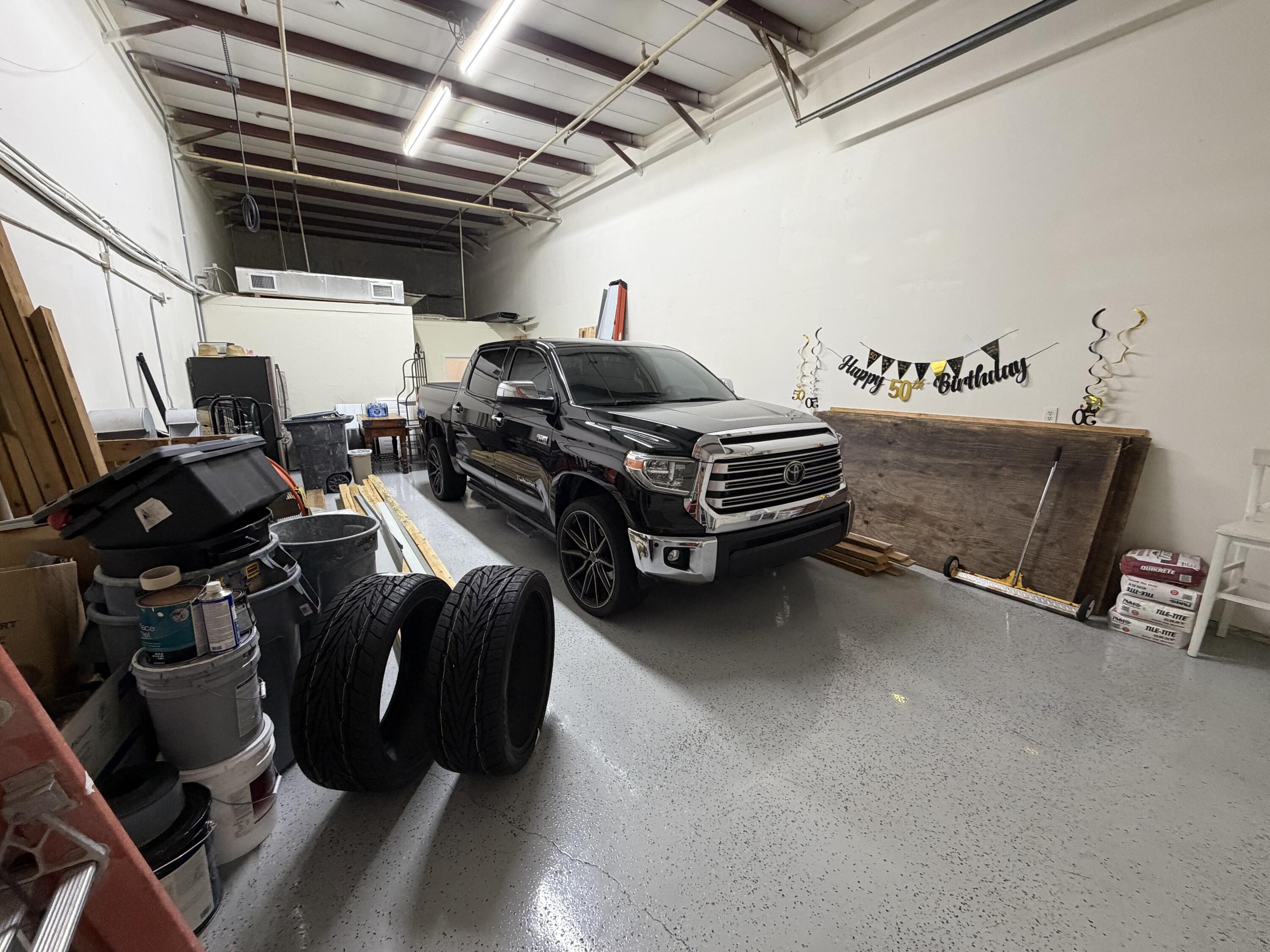 1312 Commerce Lane, Unit 3A Jupiter, FL 33458 - Photo 10 of 10 a car is parked in a garage