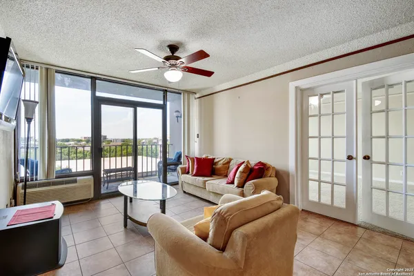 a living room with furniture and a large window