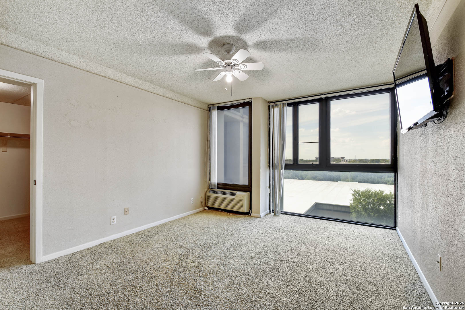 7701 Wurzbach Road, Unit 405 San Antonio, TX 78229 - Photo 19 of 42 wooden floor in an empty room with a window