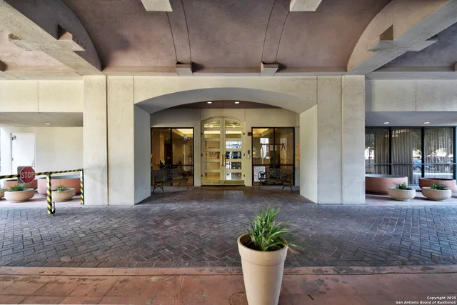 a lobby with furniture and a potted plant