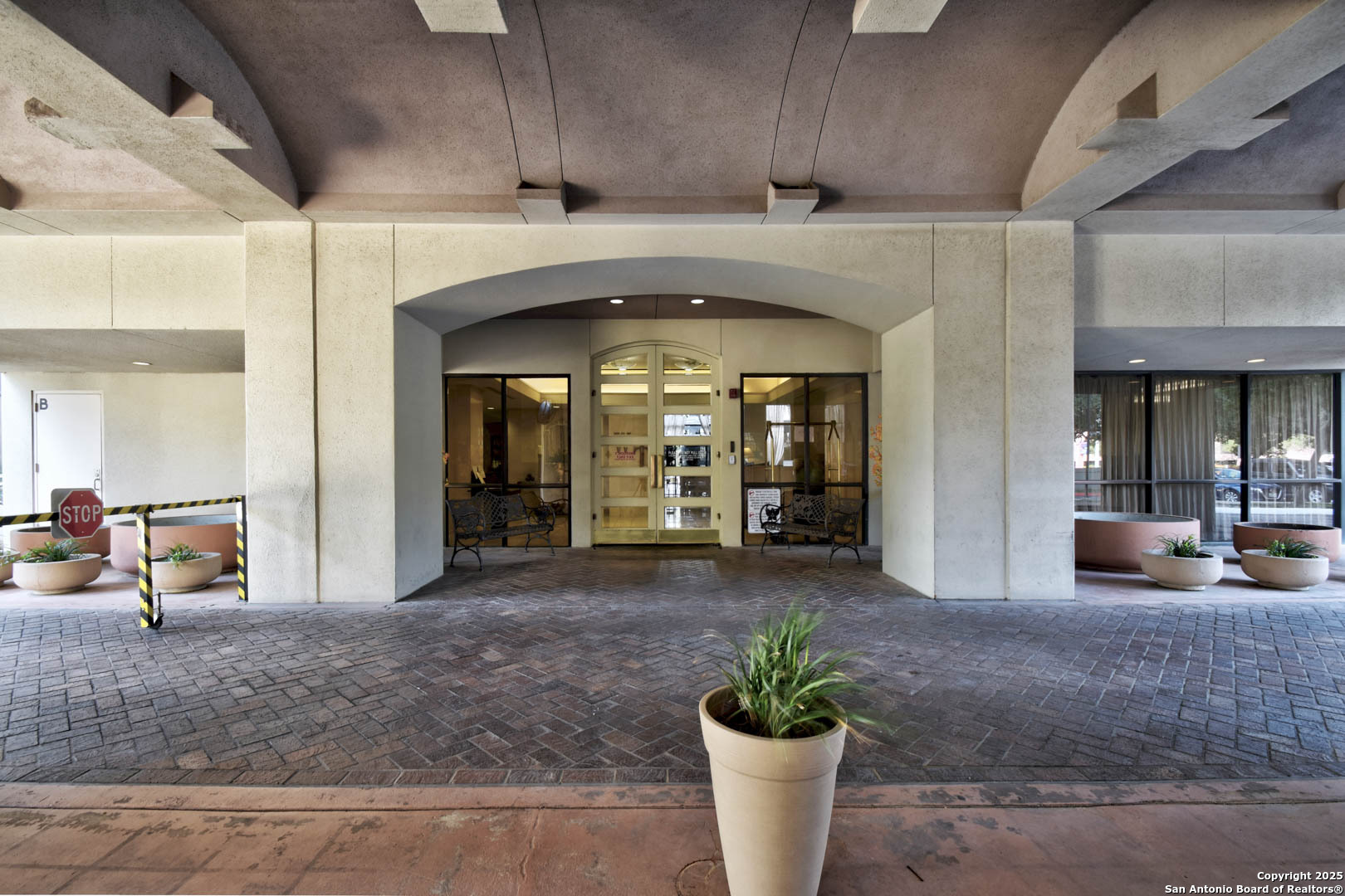 7701 Wurzbach Road, Unit 405 San Antonio, TX 78229 - Photo 23 of 42 a lobby with furniture and a potted plant