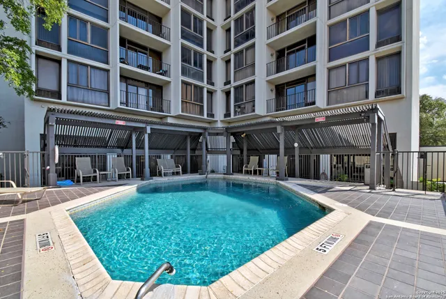 a view of a patio with a table and chairs and potted plants