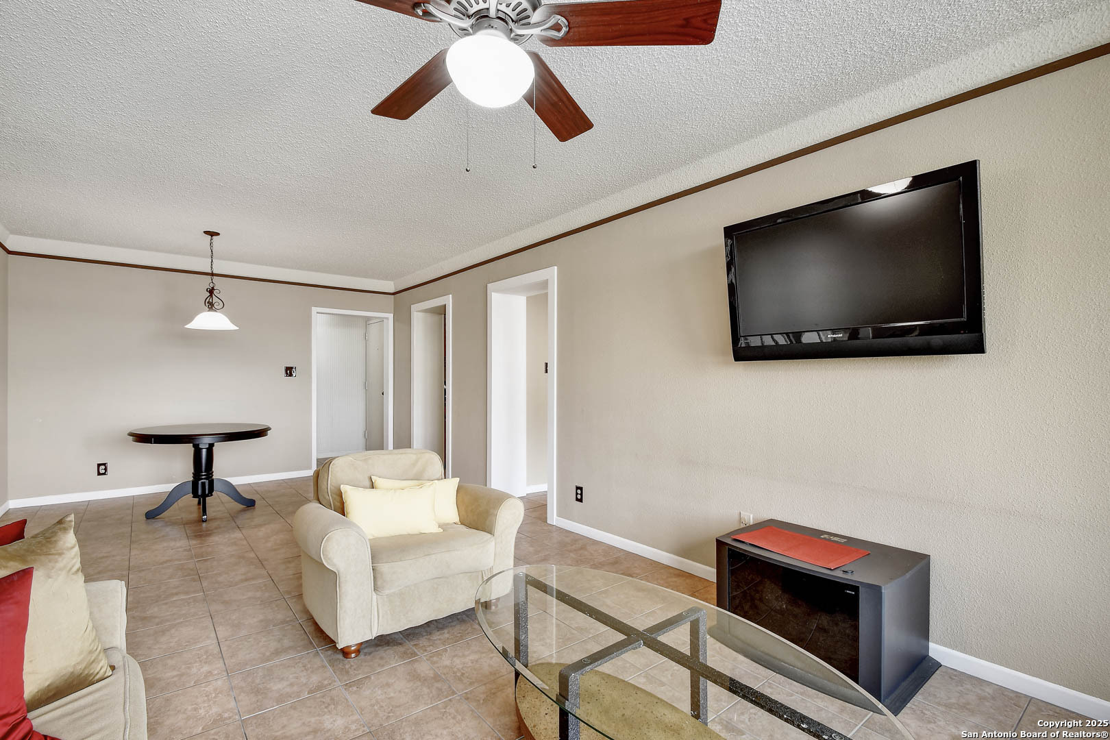 7701 Wurzbach Road, Unit 405 San Antonio, TX 78229 - Photo 6 of 42 a living room with furniture and a flat screen tv