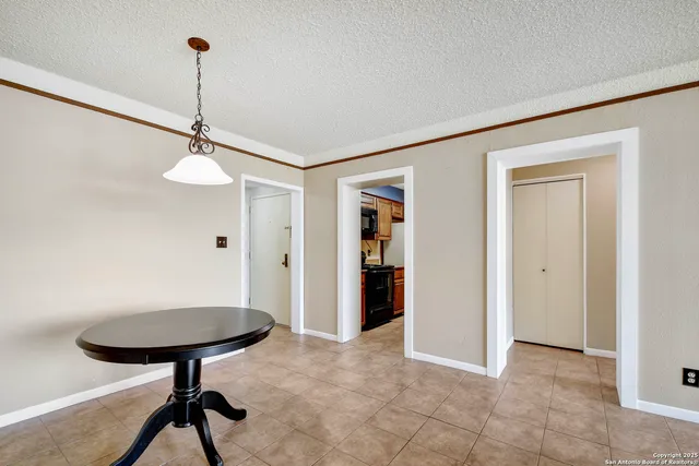 a view of a room with a chandeliers and furniture
