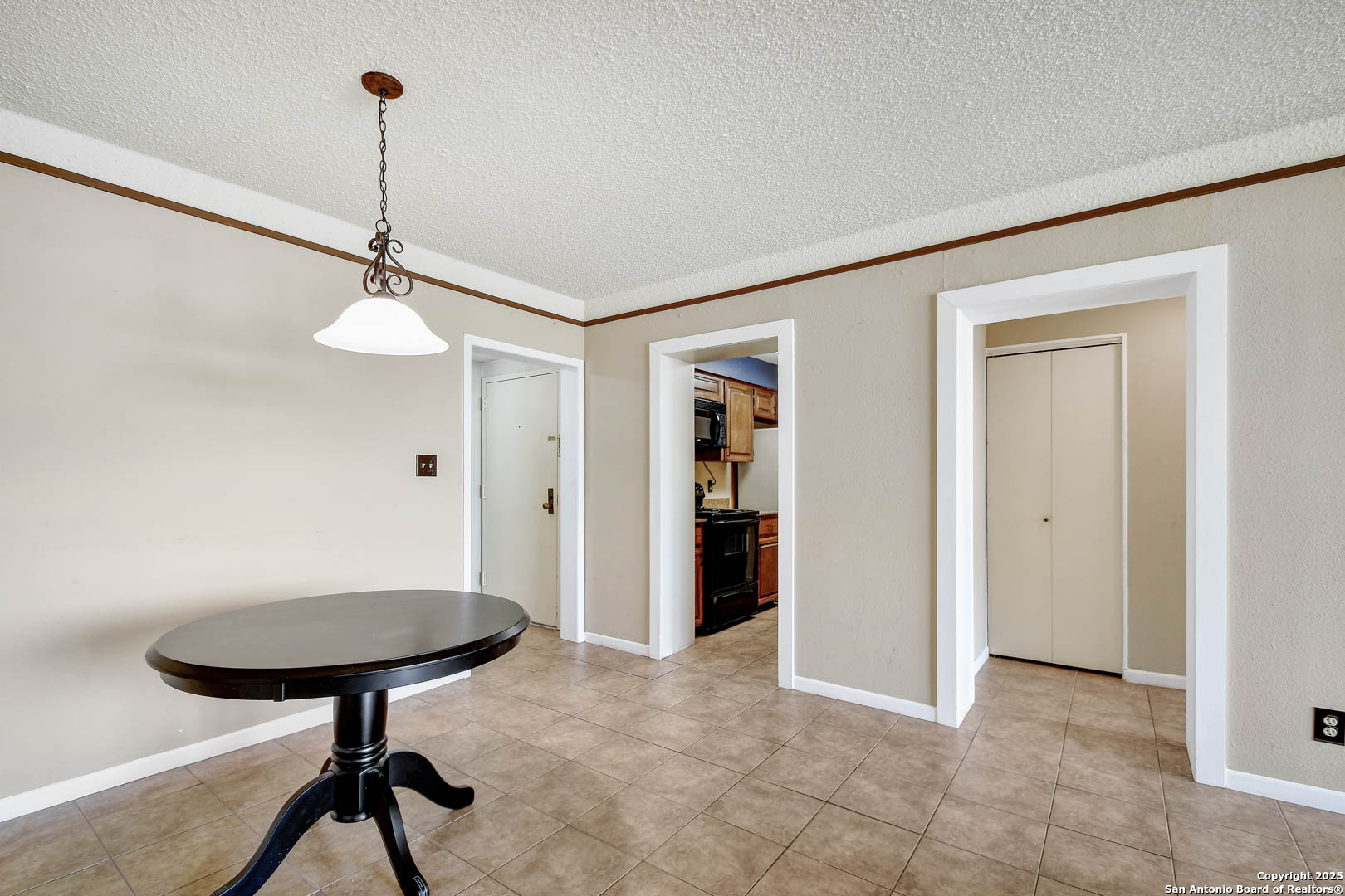 7701 Wurzbach Road, Unit 405 San Antonio, TX 78229 - Photo 8 of 42 a view of a room with a chandeliers and furniture