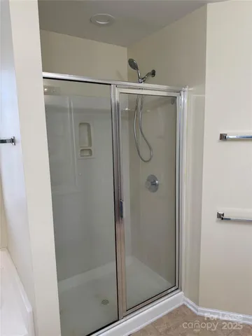 a bathroom with a glass shower door
