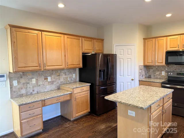 a kitchen with a sink stove and refrigerator