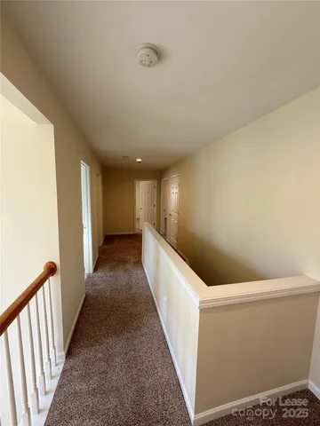 a view of a hallway with stairs