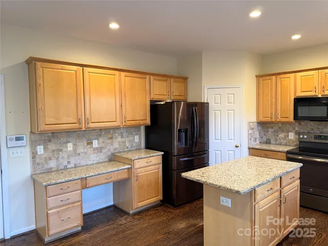a kitchen with a stove a sink and a refrigerator