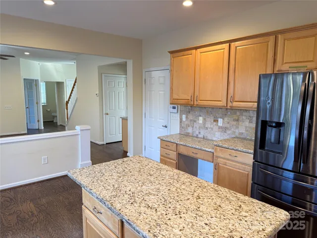 a kitchen with stainless steel appliances granite countertop a refrigerator sink and cabinets