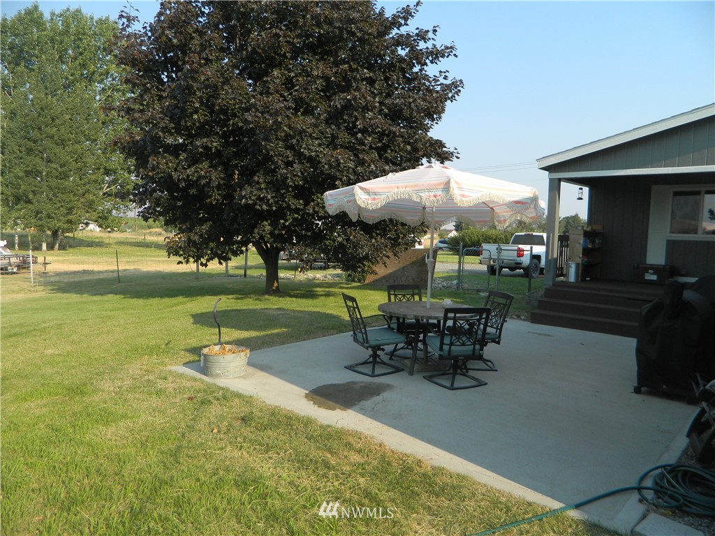41 Miller Road Omak, WA 98841 - Photo 13 of 27 an outdoor space with furniture and umbrella