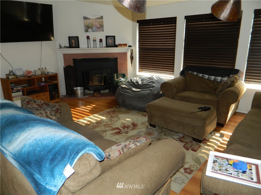 41 Miller Road Omak, WA 98841 - Photo 19 of 27 a living room with furniture fireplace and flat screen tv