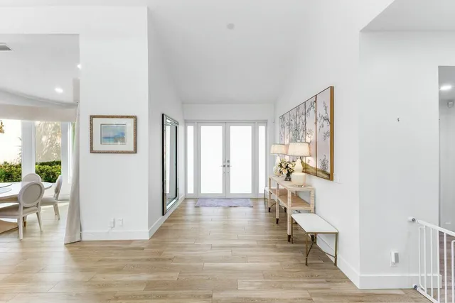 a living room with furniture and large windows