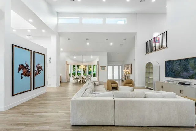 a large white kitchen with a large window