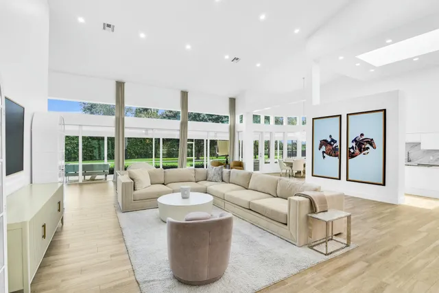 a large white kitchen with a sink and window