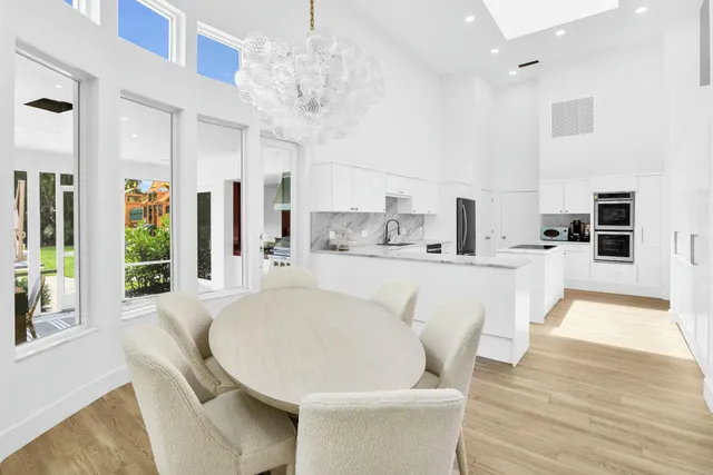 a bedroom with a bed painting on wall and a large window