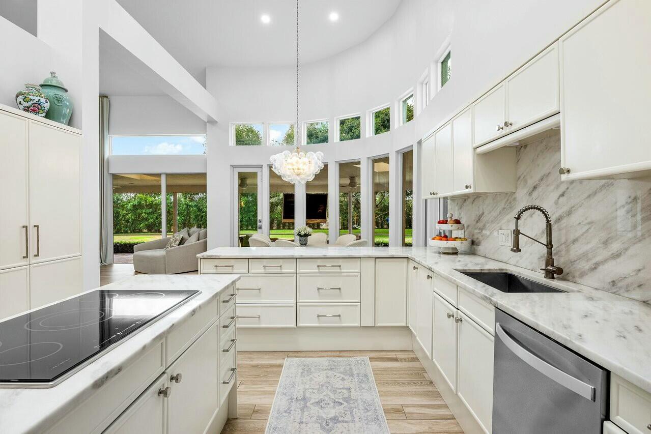 4356 Kasso Circle Boca Raton, FL 33487 - Photo 26 of 72 a large white kitchen with a sink and window