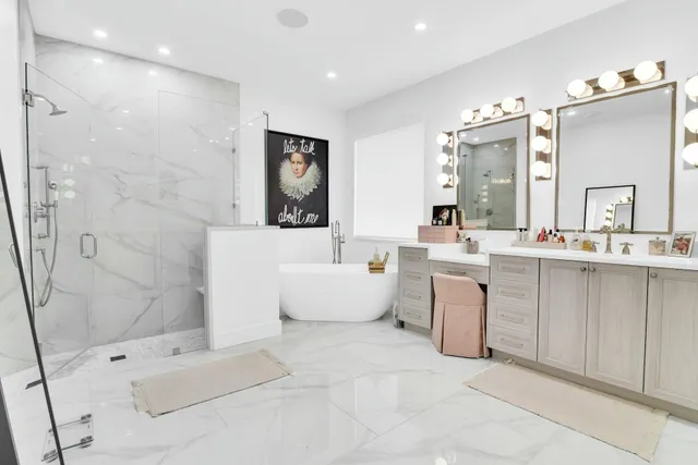a living room with furniture a flat screen tv and kitchen view