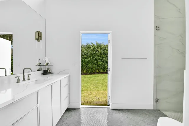a dining room with stainless steel appliances kitchen island a table chairs in it and wooden floors