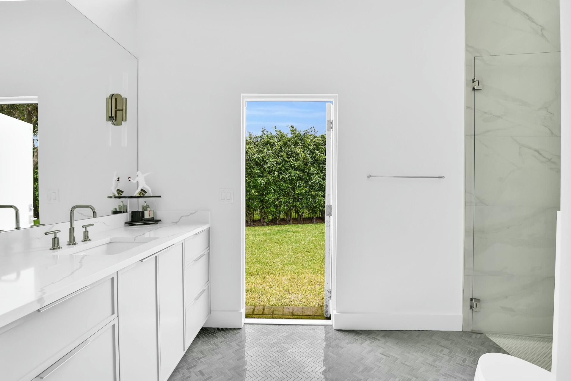 4356 Kasso Circle Boca Raton, FL 33487 - Photo 39 of 72 a bathroom with a sink and a mirror