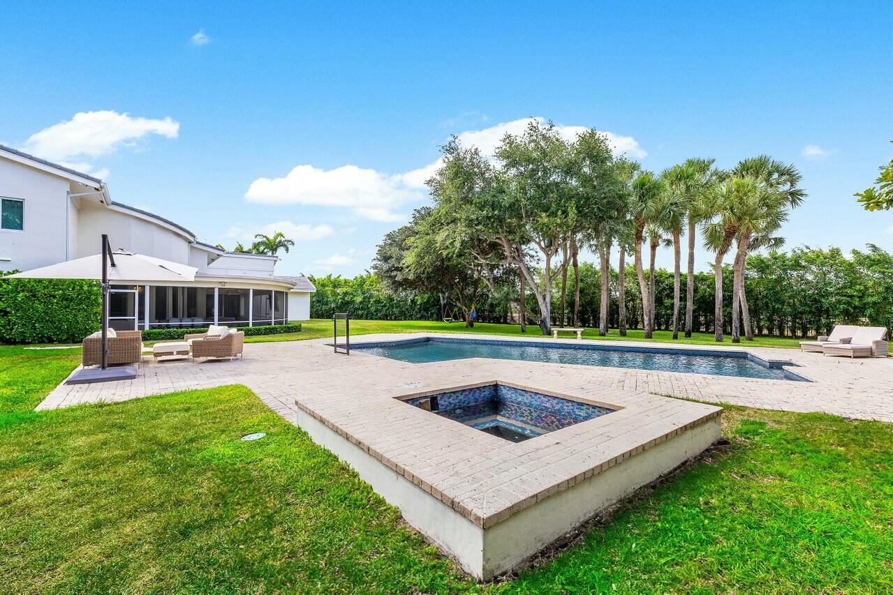 4356 Kasso Circle Boca Raton, FL 33487 - Photo 49 of 72 a view of a swimming pool with a yard