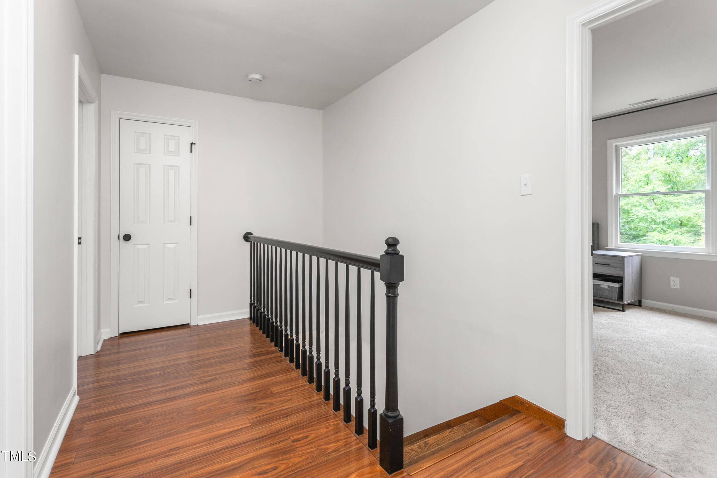 8801 Highway 157 Rougemont, NC 27572 - Photo 22 of 60 a view of a hallway with wooden floor and a bathroom
