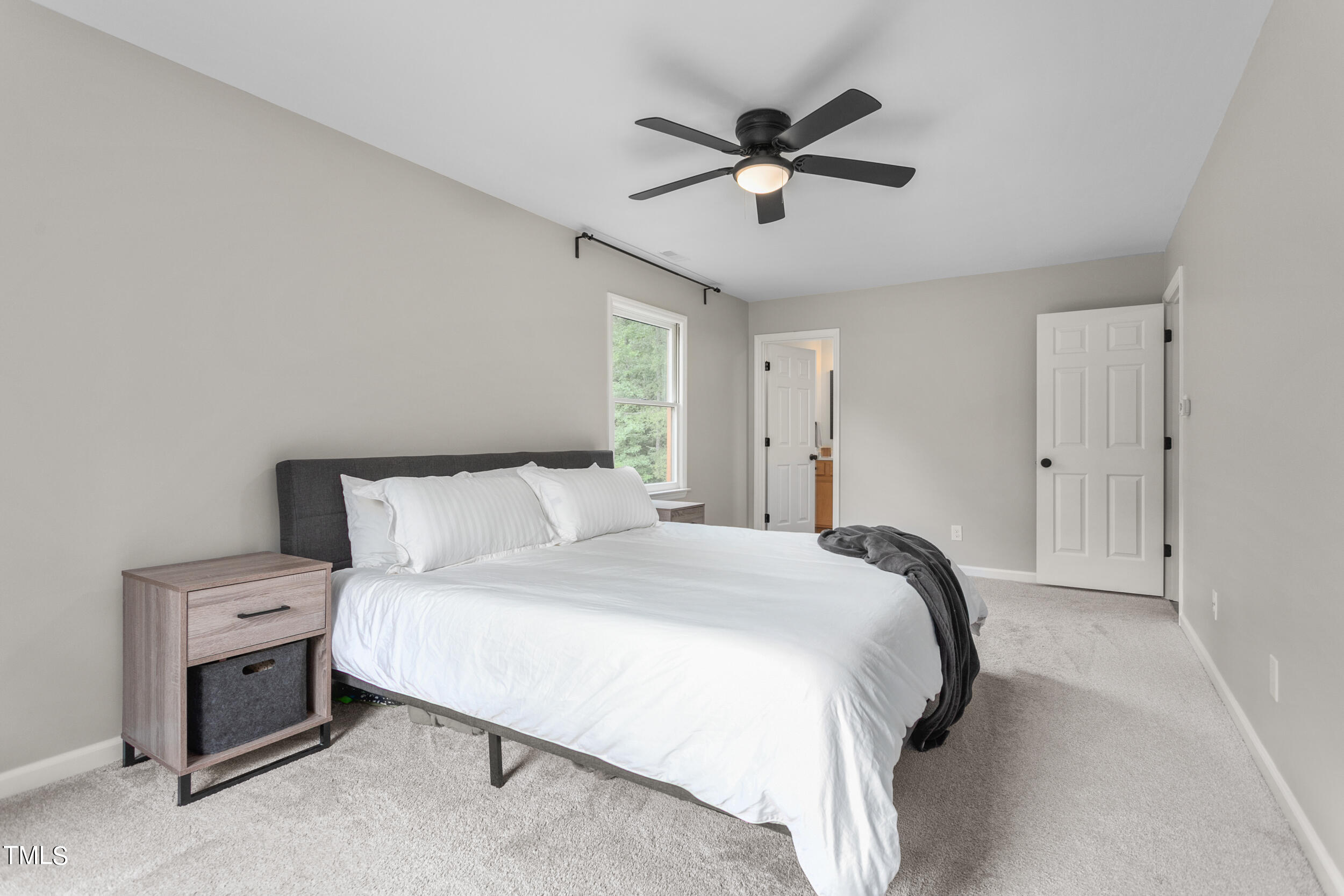 8801 Highway 157 Rougemont, NC 27572 - Photo 24 of 60 a bedroom with a bed and a chandelier