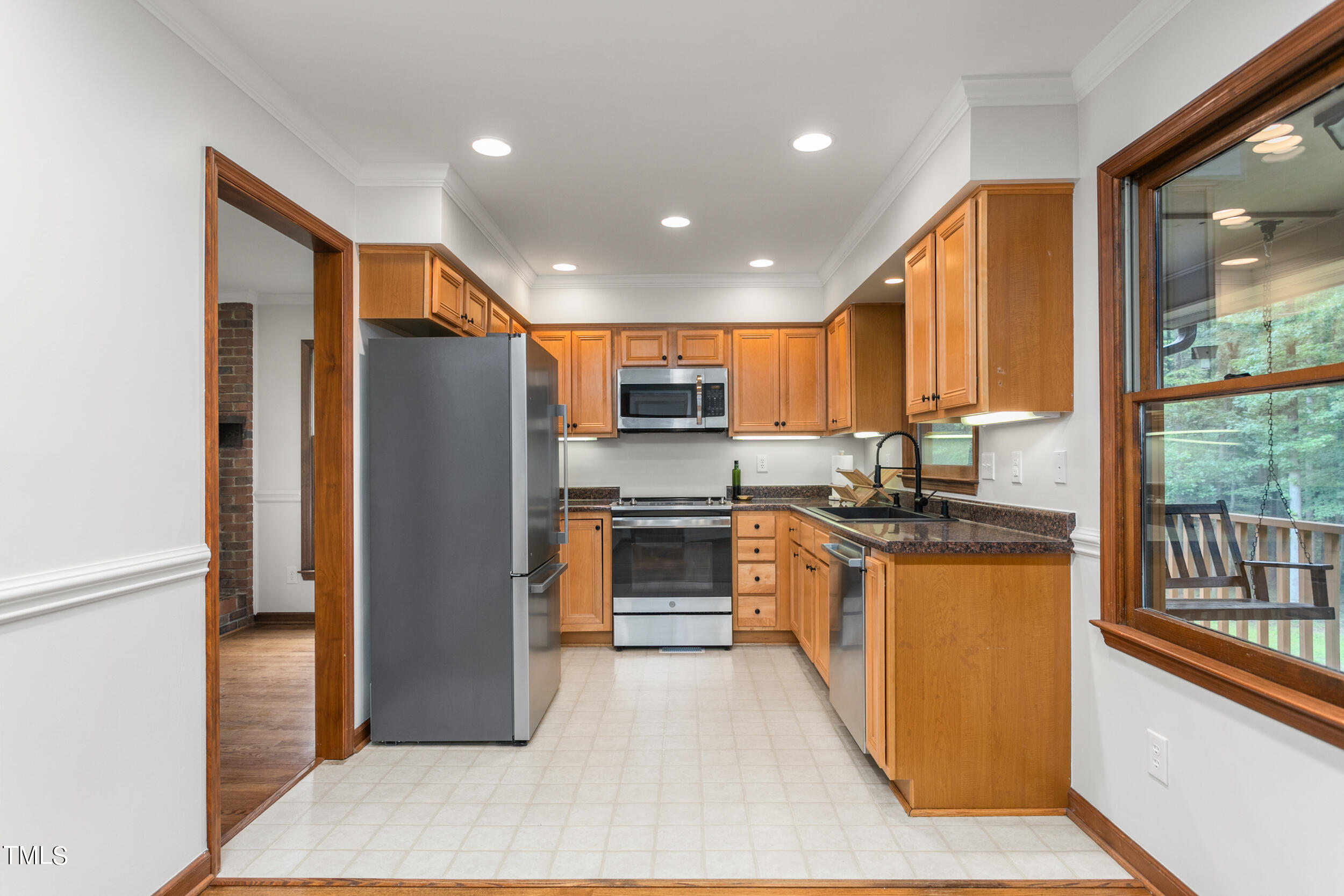 8801 Highway 157 Rougemont, NC 27572 - Photo 8 of 60 a kitchen with stainless steel appliances granite countertop a refrigerator a sink and a stove
