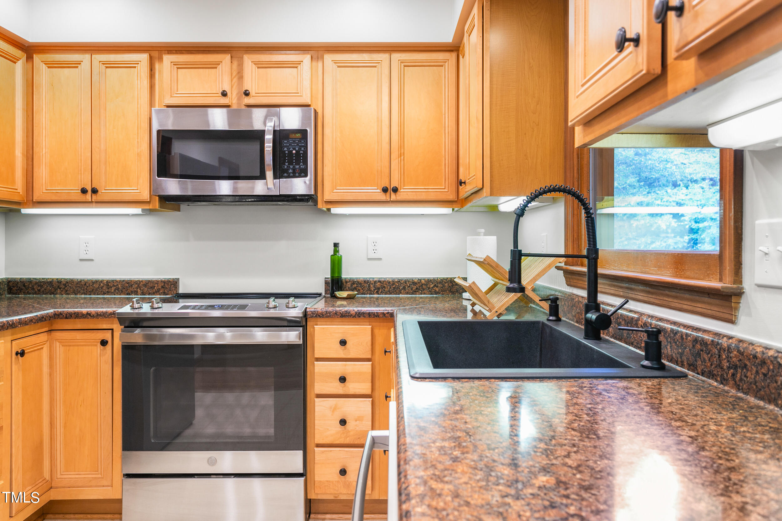 8801 Highway 157 Rougemont, NC 27572 - Photo 9 of 60 a kitchen with stainless steel appliances granite countertop a sink a stove and a microwave