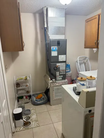 a room with furniture a rug toys and a window