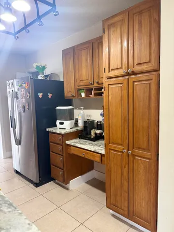 a kitchen with stainless steel appliances granite countertop a refrigerator and cabinets